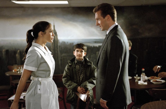(l to r) A hotel maid (Jennifer Lopez) and her son's (Tyler Garcia Posey) true identities are discovered by the Senatorial candidate (Ralph Fiennes) who has fallen for her, in Revolution Studios' romantic comedy Maid in Manhattan, distributed by Columbia Pictures. Photo: Barry Wetcher --- DATE TAKEN: rec'd. 12/2002 By Barry Wetcher Columbia Pictures HO - handout ORG XMIT: PX85411